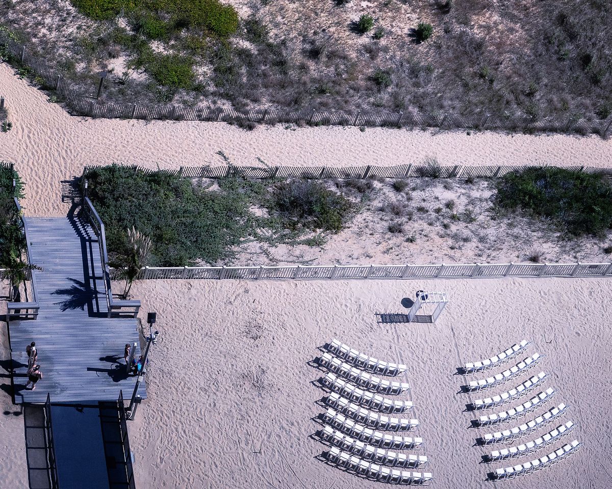arial view of empty ceremony site, the chairs are lined up facing the the ocean. sussex county, de
