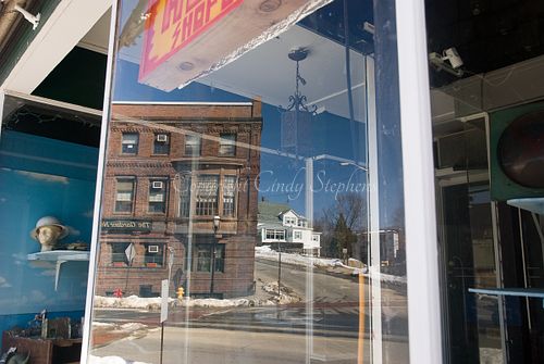 Gardner Massachusetts store window, helmet, snowy street, brick building.