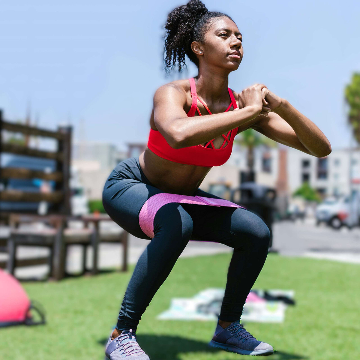 Woman demonstrating proper squat technique to strengthen glutes and hips for managing menopause-related joint pain