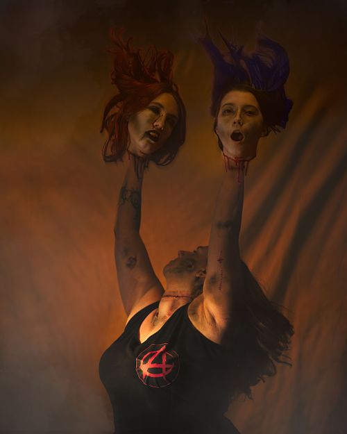 A zombie cheerleader with her severed head pom poms.