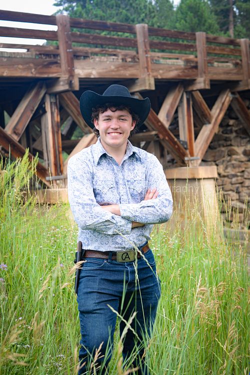 young man in front of bridge